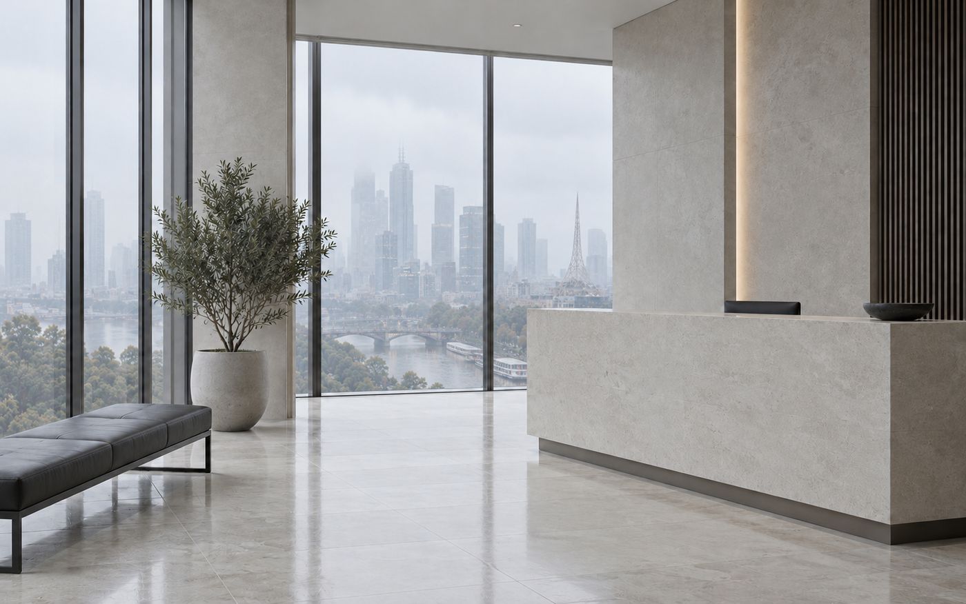 The firm's reception, with a stone desk and city views
